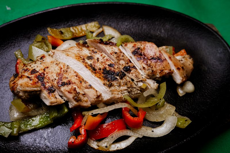 Chuys sizzling chicken fajitas on cast iron skillet